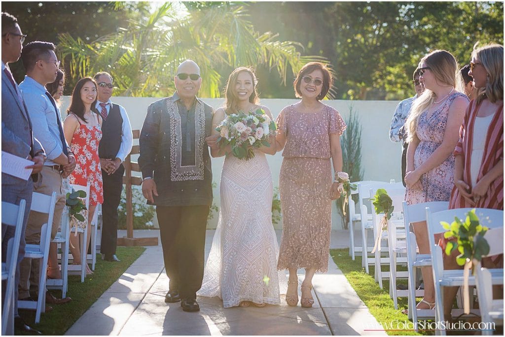 Bride walking down the aisle with parents