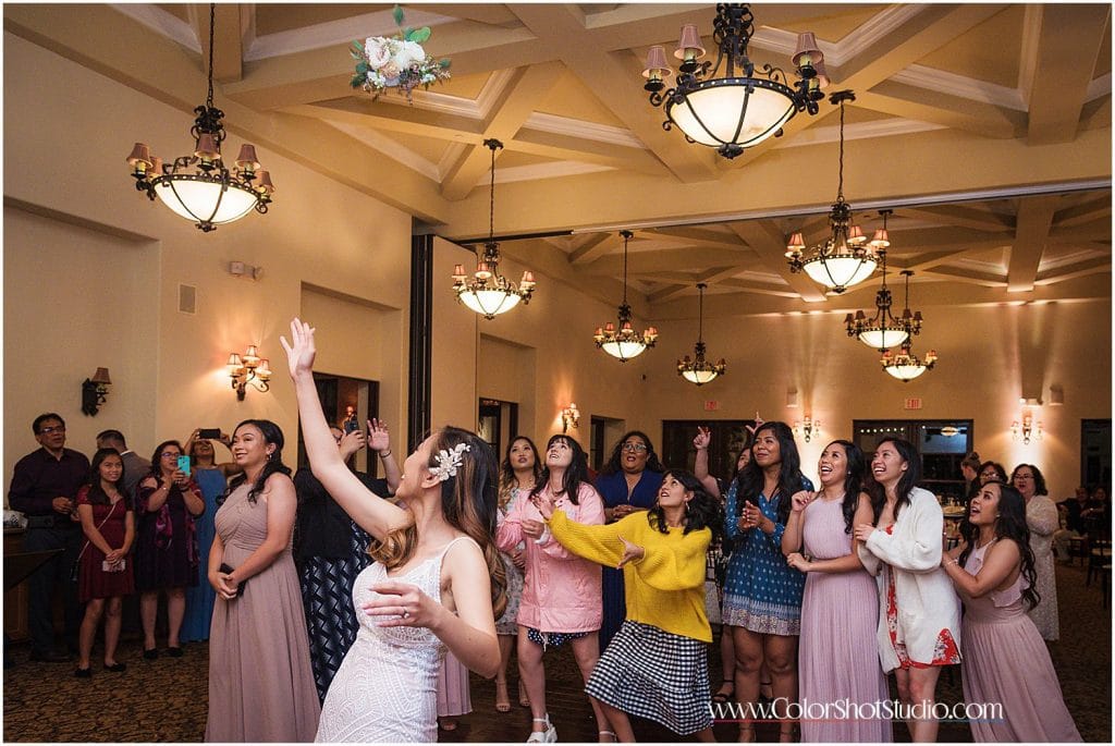 Bouquet toss bride and her friends