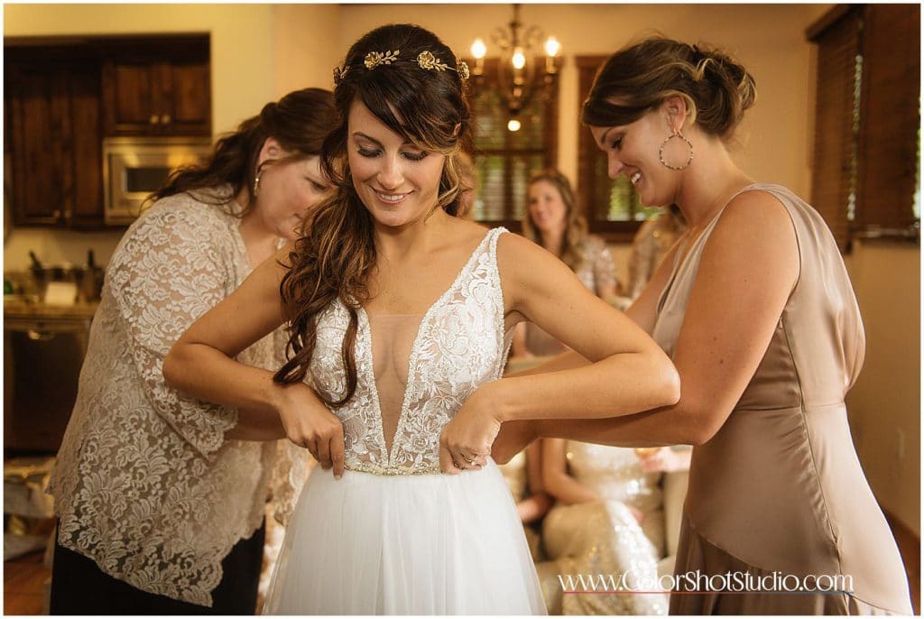 Bride's mother zipping up her dress Omni la costa resort wedding photography by color shot studio