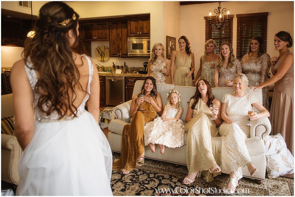 Brides maids looking at the  bride for the first time in her wedding dress