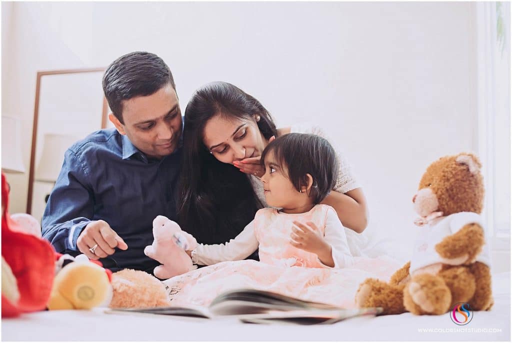 family of three book reading